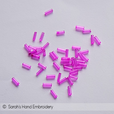 DIY concept. Top view on tools and accessories for embroidery brooches with  beads, bugles, rhinestones and gimps. Sets of beads in containers on pink  background. Fashion hobby, handmade gifts Stock Photo